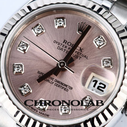 Close-up of the 18k white gold fluted bezel on a Rolex Datejust 179174, highlighting the light-reflecting edges and polished steel case.