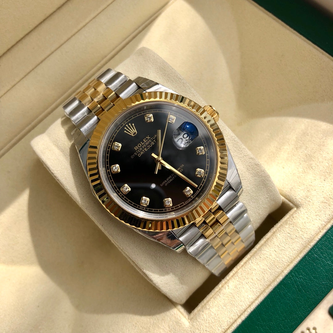 Close-up of the Rolex 126233 black diamond dial featuring 18k yellow gold settings and the signature Cyclops date window.
