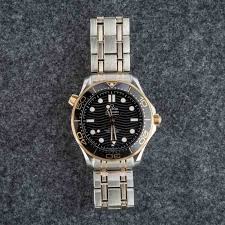 Omega Seamaster Diver 300M 44mm two-tone black replica watch side profile crown detail – chronolab.gr