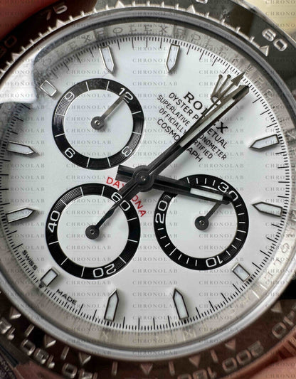 Direct macro shot of the intense white dial with black concentric chronograph rings and 3D markers on Rolex Daytona 116500 Clean Factory