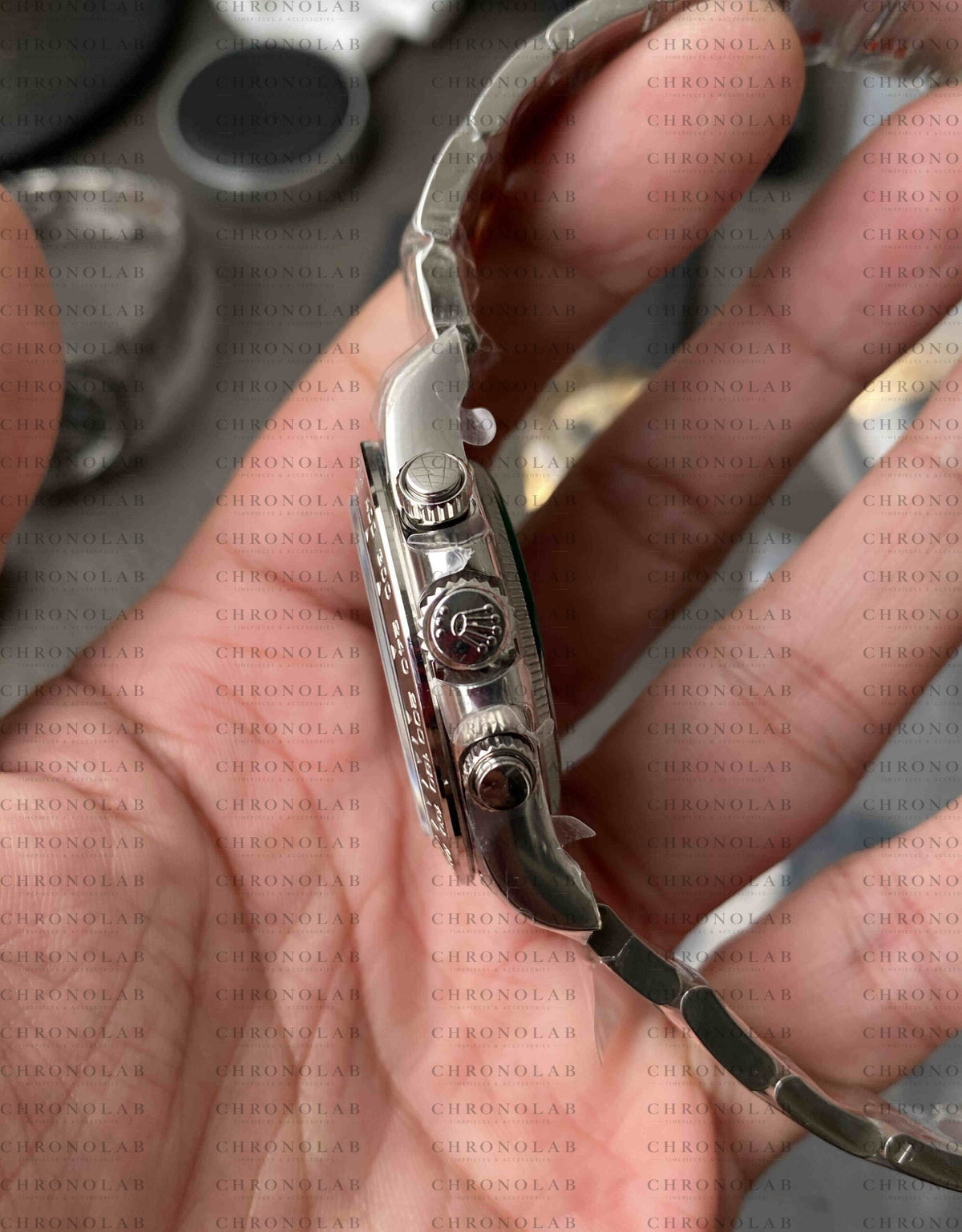 Angled view highlighting the threaded Triplock winding crown and screw-down chronograph pushers on Rolex Daytona 116500 Clean Factory