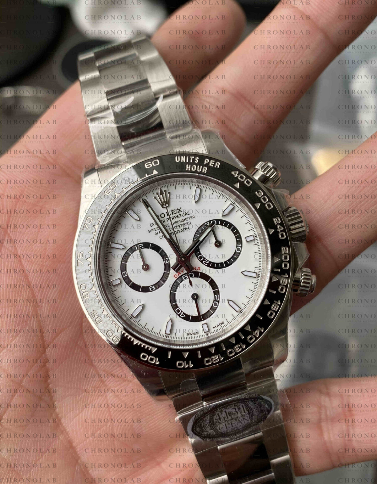 Detailed close-up of the White Panda dial, black chronograph sub-dials, and Cerachrom ceramic bezel on Rolex Daytona 116500 Clean Factory
