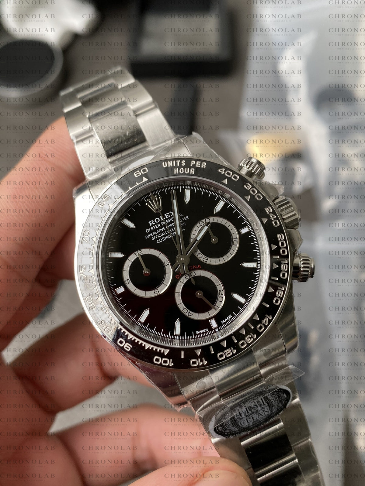 Detailed close-up of the Black dial, white chronograph sub-dials, and Cerachrom ceramic bezel on Rolex Daytona 126500LN Clean Factory