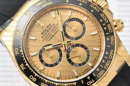 Detailed close-up of the Golden dial, black chronograph sub-dials, and Cerachrom ceramic bezel on Rolex Daytona 126518LN Clean Factory