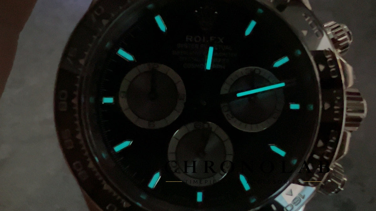 Dark room lume shot showcasing the bright ice blue Swiss Super-LumiNova BGW9 illumination on Rolex Daytona 126519LN Clean Factory V3