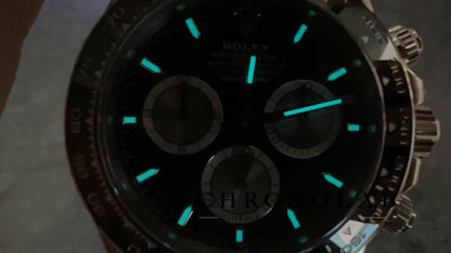 Dark room lume shot showcasing the bright ice blue Swiss Super-LumiNova BGW9 illumination on Rolex Daytona 126519LN Clean Factory V3