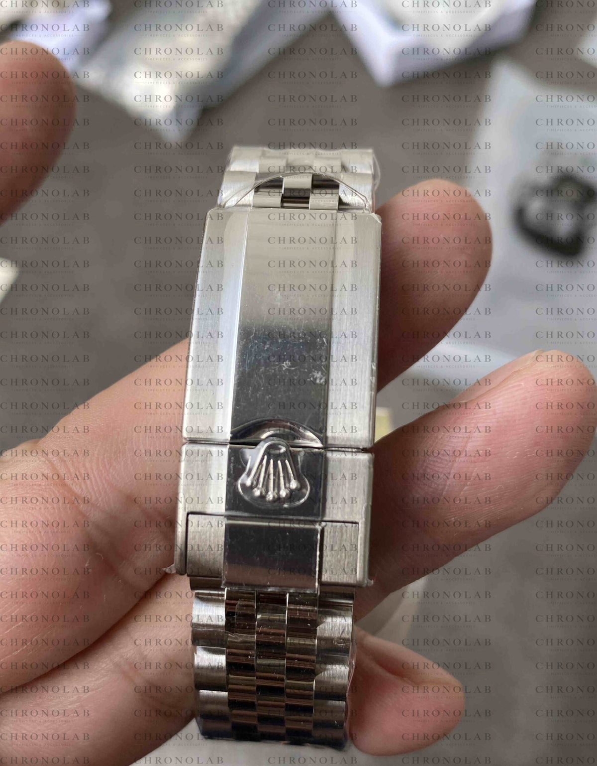 Macro close-up of the 904L stainless steel folding Oysterlock safety clasp with clean crown coronet engraving on Rolex GMT-Master II Pepsi Clean Factory V3
